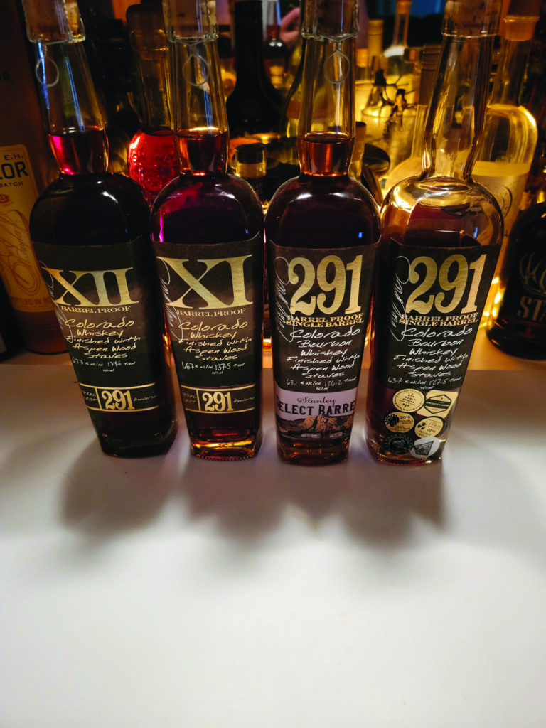 Distillery 291 displays four of their whisky bottles on a counter