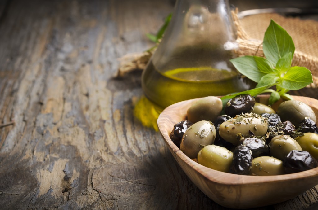 Olives,and,olive,oil,on,rustic,wooden,table