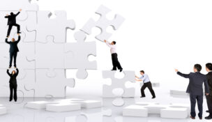 business team work building a puzzle isolated over a white background.