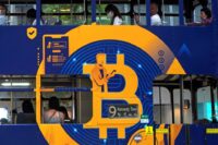 Bitcoin office building, featuring the bitcoin symbol and people working in their office spaces.