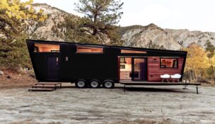 black Land Ark RV parked in front of a mountain range.