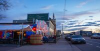 Denver, Colorado, United States - 4.7.2023: RiNo neighborhood at sunset. People sitting at a brewery patio